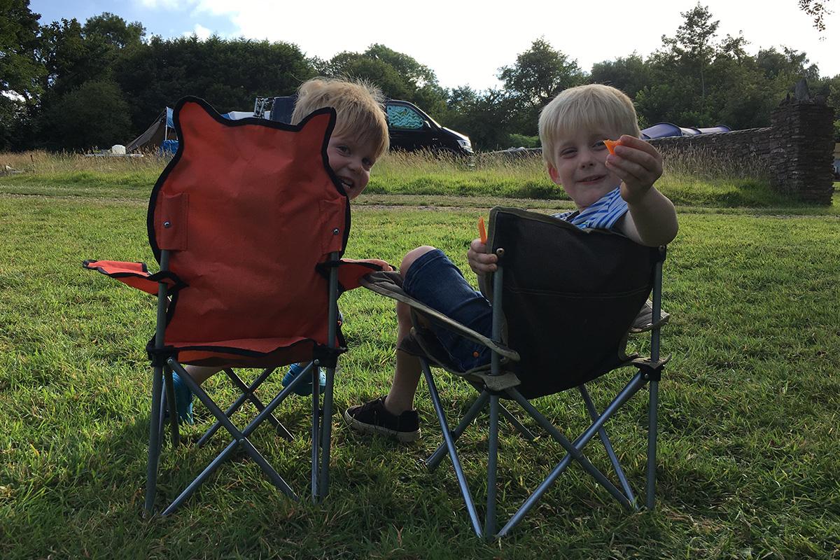 Boys sitting in camp chairs