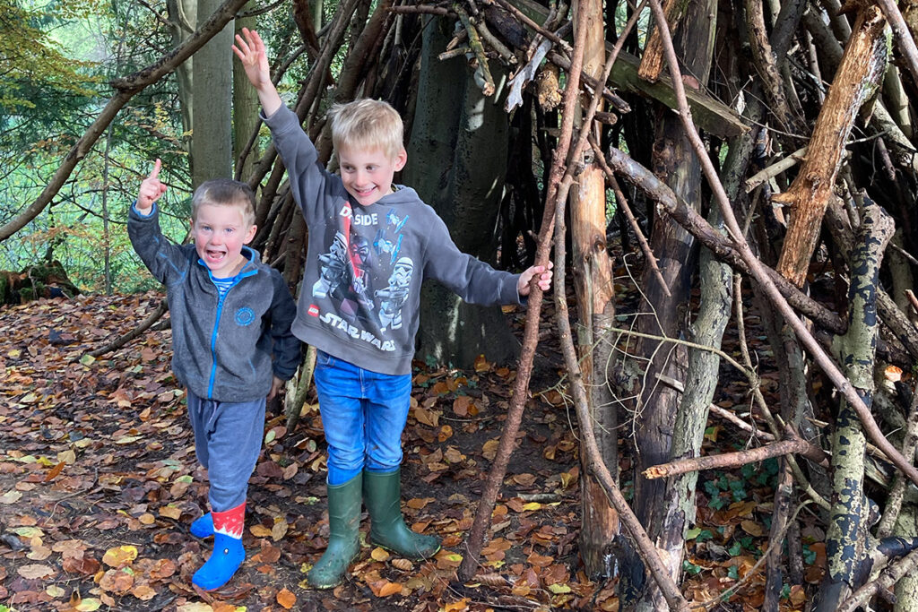Boys next to a den