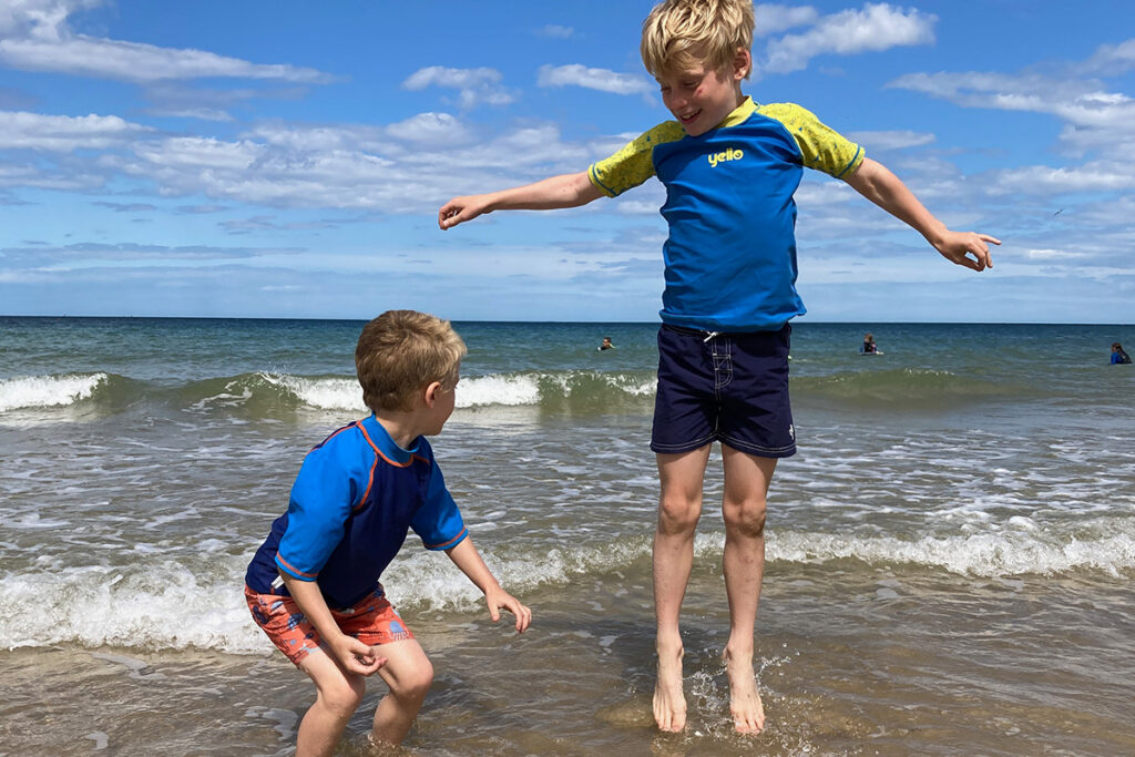 Camping in North Norfolk, two boys enjoying the seaside