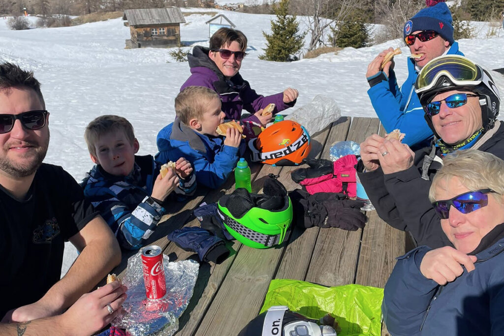 Family eating a picnic on the piste