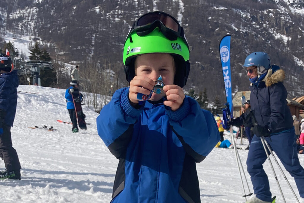 Boy with ski school medal